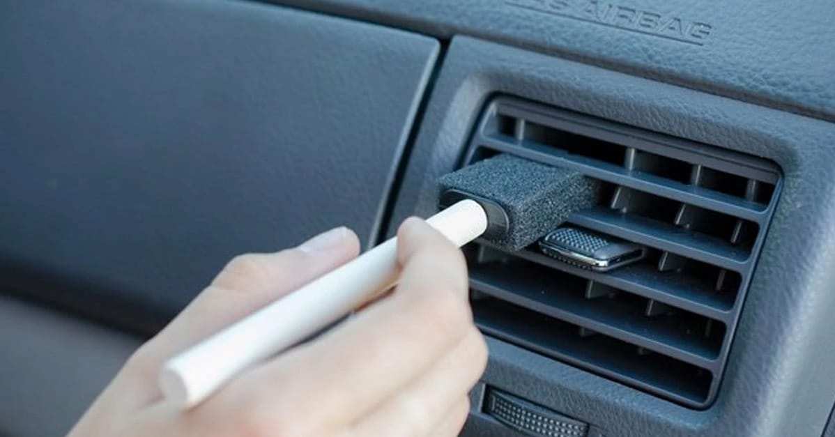 cleaning air vents with foam brush