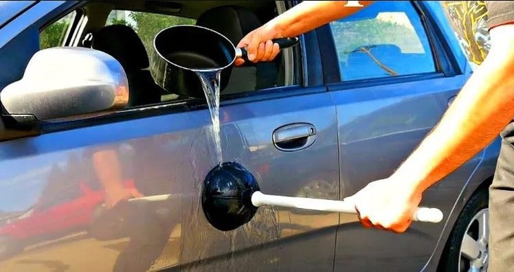 fixing a dent with hot water and a plunger