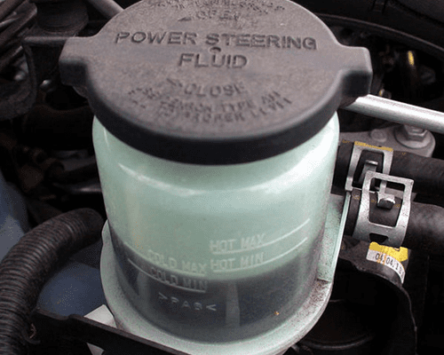 if the power steering fluid level in the reservoir is low or empty, a possible leak should be suspected power steering fluid reservoir