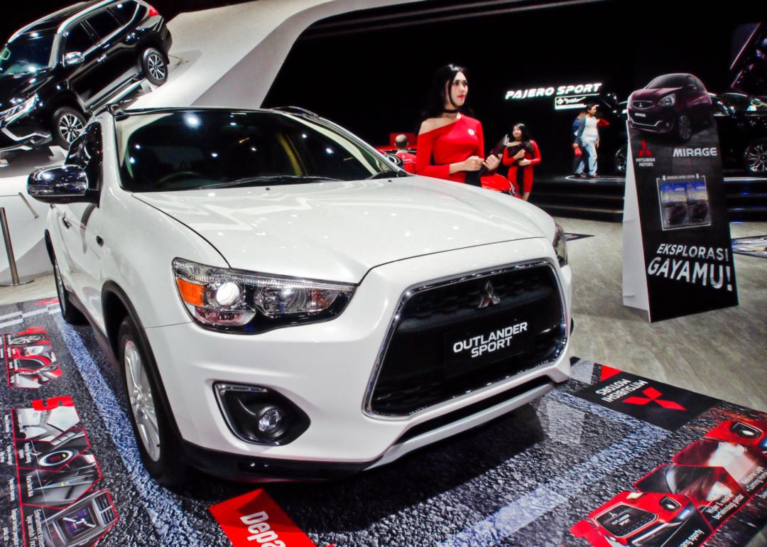 a white mitsubishi outlander sport in a showroom.